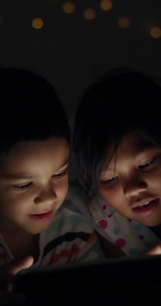 夜に自宅でタブレットで笑顔 または子供たちは 家族の絆を結ぶことを学び 教育します ゲームやボケのビデオを見るための技術のハッピーな子供たち — ストック動画
