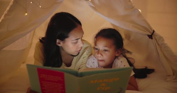 女儿或在帐篷里看书 快乐或团结在一起 促进孩子在家里的发展 晚上在室内放松一下 听童话故事 开心和爱 兴奋地学习 — 图库视频影像