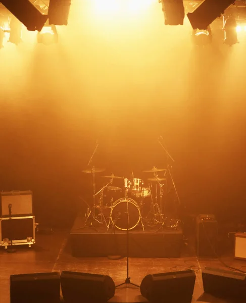 Concert, band and drums at stage for performance with instruments for live sound or gig. Music festival show, ready or background with lights or speakers in an empty theater at night for a rock event.