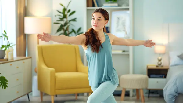 Woman, yoga and stretching in home living room for wellness, fitness and relax for mind, body and zen. Girl, exercise and workout for mindfulness, self care and health for peace of mind in Dublin.