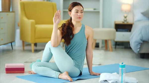 Woman, yoga and stretching for fitness, wellness in healthy spiritual zen exercise for mental wellbeing at home. Female in calm, relax and peaceful exercising workout for mind, body and spirit on mat.