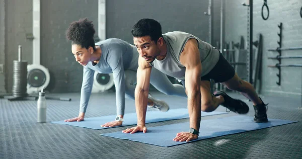 Couple, fitness and gym workout of training friends together for a core strength exercise for abs. Strong, sports and athlete wellness cardio of people doing a sport in a health club or studio.