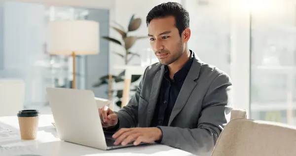 Man in office with laptop, market research and notes for social media review, business feedback or planning. Thinking, search and businessman networking online for startup, website and writing report.