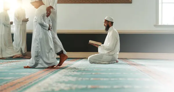 Quran, islamic and man reading for faith in a mosque for praying, peace and spiritual care in holy religion for Allah. Respect, Ramadan and Muslim person with kindness, hope and humble after worship.