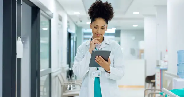 Typing, tablet or doctor in hospital with research on social media to search for medicine news online. Woman reading, smile or medical healthcare nurse browsing on technology for telehealth or meme.