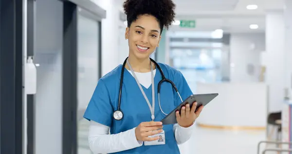Face, tablet or doctor in hospital with research on social media to search for medicine info online. Happy woman, smile or medical healthcare nurse browsing on technology for telehealth in clinic.