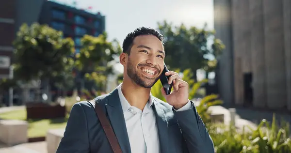 Phone call, smile and businessman commuting in city to work with communication for legal deal. Happy, talking and professional male attorney on mobile conversation for law case walking in urban town