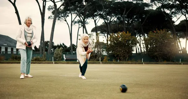 Bowls, focus and celebration with senior woman friends outdoor, cheering together during a game. Motivation, support or competition and elderly people cheering while having fun with a leisure hobby.