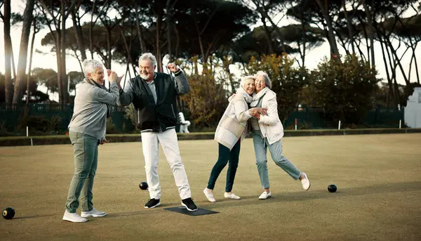 Bowls, high five and celebration with senior friends outdoor, cheering together during a game. Motivation, support or applause and a group of elderly people cheering while having fun with a hobby.