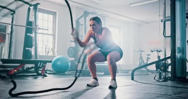 女子用钢丝绳挥动肌肉以促进肌肉生长 力量发展和力量锻炼 剧烈运动 挑战和艰苦工作中的快速动作 耐力和运动员的适应力 — 图库视频影像