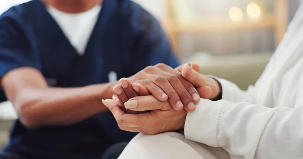 Empathy, closeup and nurse holding hands with woman for consulting with kindness, comfort or support. Sorry, understanding and health specialist with patient in consultation room, solidarity or hope.