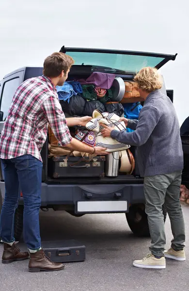 Men, friends and luggage in car trunk on road trip or camping outdoor for holiday, vacation or adventure. Male people, bags and unpacking boot or transportation together in Europe, journey or travel.