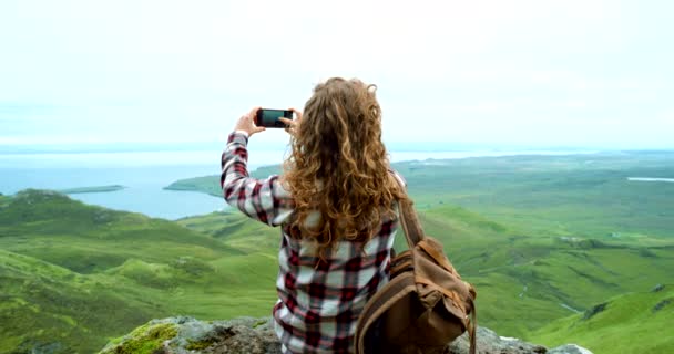 旅行ブログ アドベンチャー 休暇のための写真付きの自然の中で電話 ハイキング スマートフォン トレッキング 女の子は崖の上のソーシャルメディアメモリで山でライブストリーミング休暇の旅をします — ストック動画