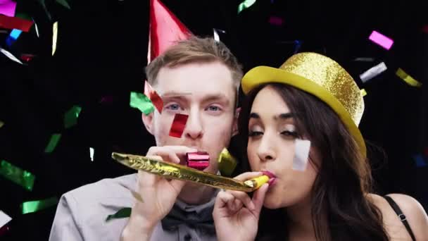 Couple Blow Party Horn Confetti Studio Celebration Success Winning Competition — Stock Video