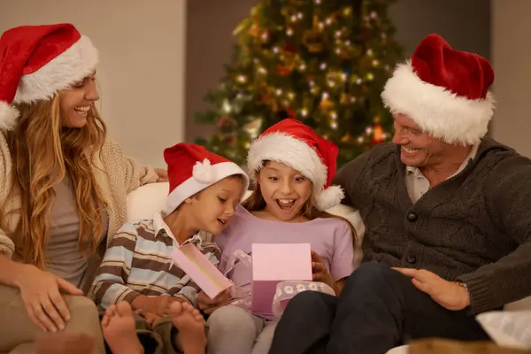 Parents Girl Children Sofa Christmas Present Surprise Happy Bonding Festive — Stock Photo, Image
