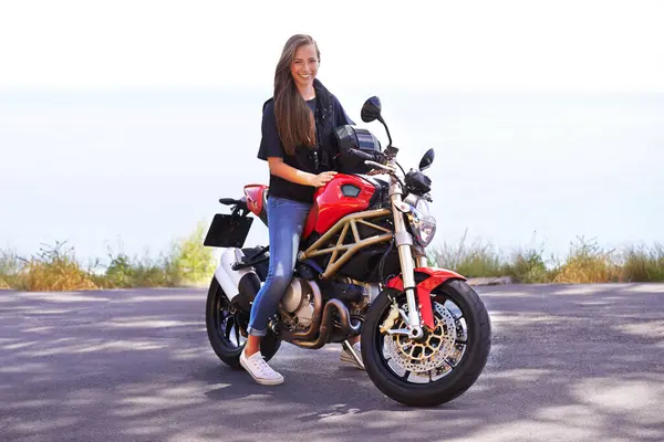 Happy woman, rider and motorcycle by the ocean for road trip, travel or outdoor holiday in nature. Female person or biker with smile on hot ride or bike with helmet for transport on mockup space.