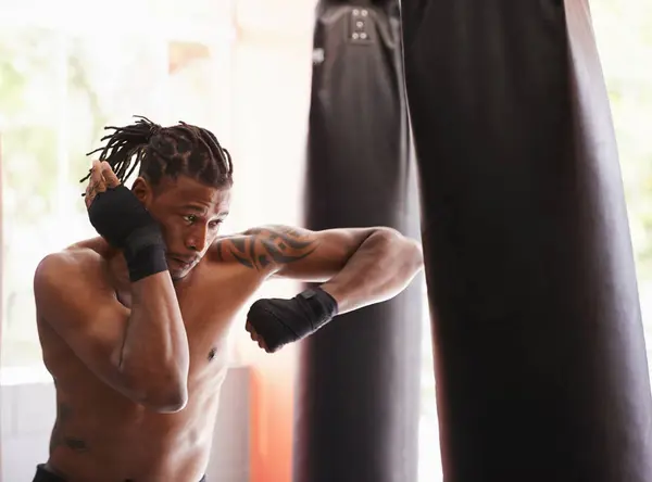 挑戦または競技トレーニングのためのボクシングジムのフィットネス パンチバッグと黒人男性 スポーツクラブで自信を持ってトレーニングでパワー そして深刻なチャンピオンボクサー — ストック写真