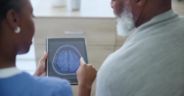 脳スキャン 治療または診断の説明のための看護師 シニアマン タブレット 神経学における高齢者との技術コンサルティング — ストック動画