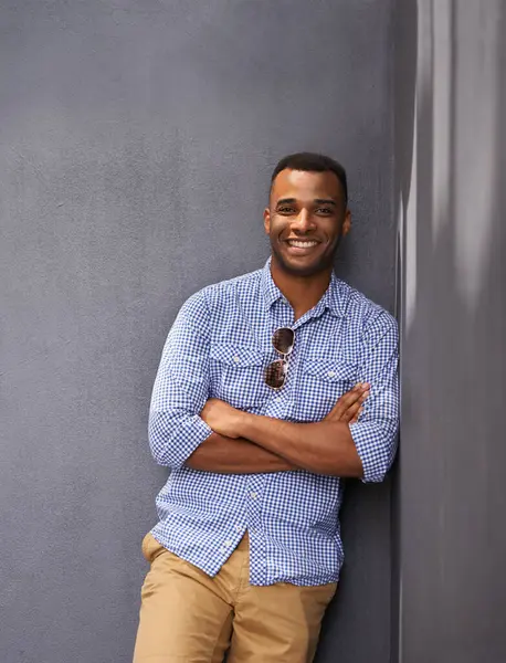 Man, smile and cool fashion in portrait by wall background, style and gen z outfit in outdoors. Happy black male person, university student and pride for aesthetic, confident and trendy clothes.