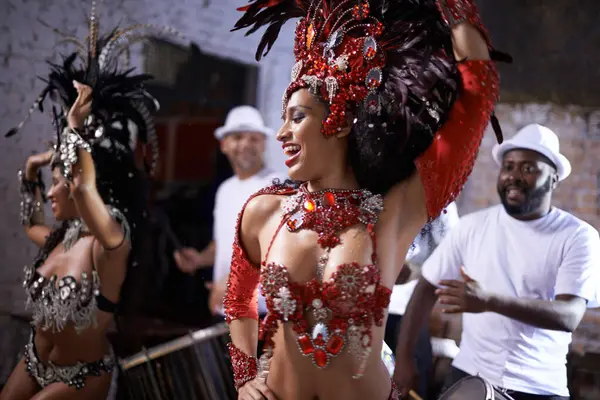 Happy woman, samba and dance at music festival, carnival or night performance with costume and band. Excited dancer, group and drummer for event, celebration and culture or history in Rio de Janeiro.
