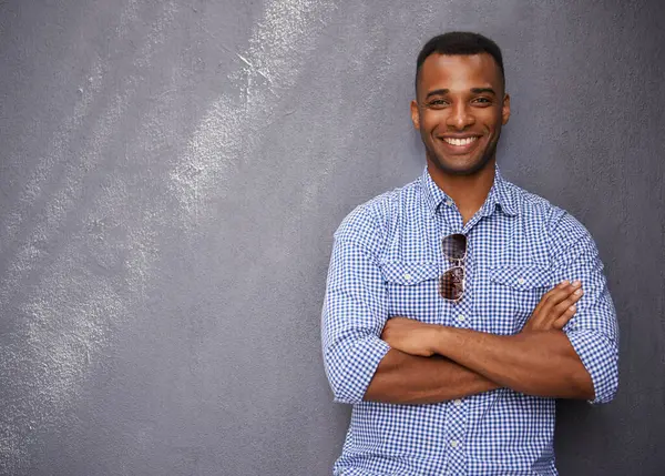 Man, smile and fashion or style in portrait by wall background, cool outfit and mockup space. Happy black male person, university student and outdoors for aesthetic, confident and trendy clothes.
