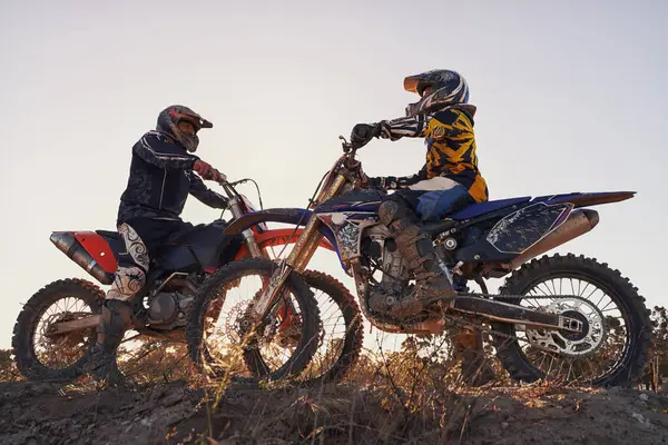 Sport, racer or people on motorcycle outdoor on dirt road with relax after driving, challenge or competition. Motocross, motorbike or dirtbike driver with helmet on offroad course or path for racing.