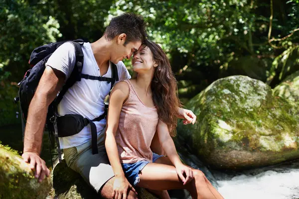 Romantic, nature and couple by river for hiking, trekking and adventure for wellness, relax and explore. Dating, love and happy man and woman on holiday, vacation and travel on weekend for bonding.
