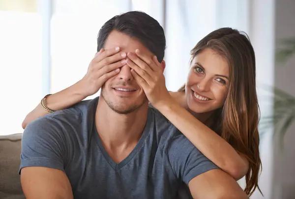 Portrait, smile and couple with surprise in home, love and happy people bonding together for romance. Face, man and woman covering eyes for connection, care and healthy relationship in living room.