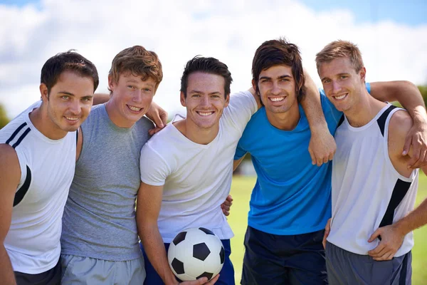 Soccer, men and hug in portrait on field at game with fitness, exercise and happy in nature. People, teamwork and embrace with pride for support, solidarity or football with friends in competition.