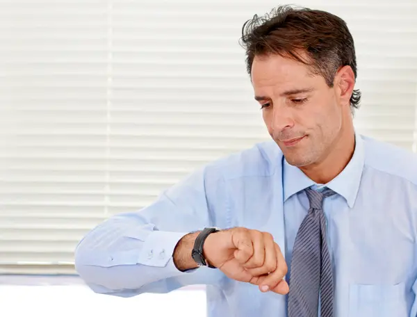 Businessman, watch and late for office job and appointment or schedule at looking serious. Time, alarm and male person checking calendar for control of clock with anxiety for career compliance.