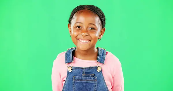 Child face, smile and studio with green screen and a happy girl feeling cute and sweet. Isolated, youth and background with a portrait of a little kid model with casual fashion and children clothes.