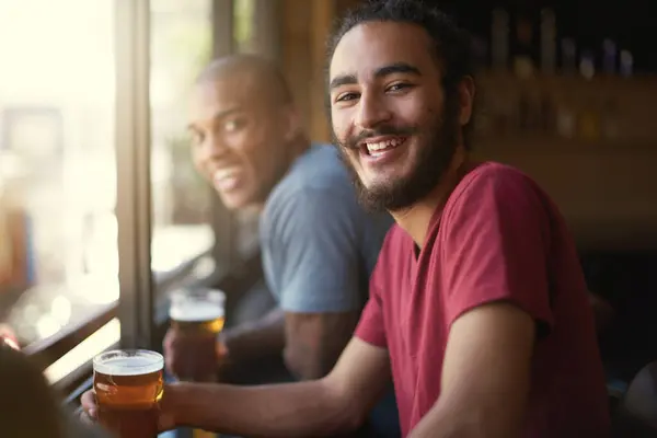 Male people, beer and chill at pub, smile and relax indoor for fun and bonding in summer to destress. Friends, bar and funny for social, guys and alcohol together and laughing for fun and weekend