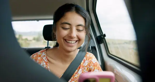 Woman, phone and road trip in car with laugh, meme and comic video on internet on road for travel. Girl, smartphone and reading in vehicle with funny blog, social media post or story with transport.