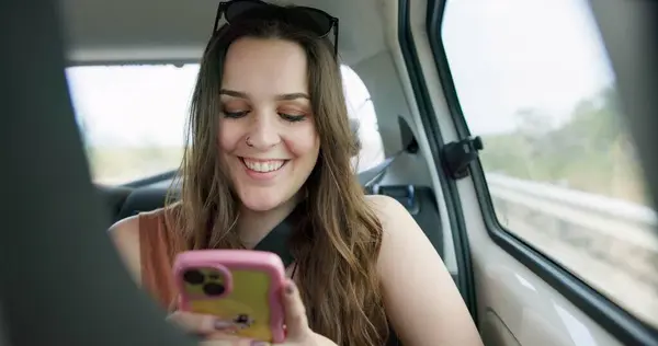 Happy woman, phone and social media in car for travel, communication or networking in transportation. Female person smile on mobile smartphone in vehicle for online chatting, texting or road trip.