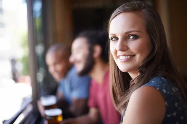 Portrait, happy and a woman at pub to relax, cheerful or positive facial expression for leisure at restaurant tavern. Face, bar and smile of young female person or casual customer at cafe for alcohol.