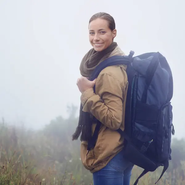 Happy woman, hiking and portrait in nature with backpack and morning fitness for adventure in mountain. Young person, positive and face in outdoor exercise and walk on journey in sweden countryside.