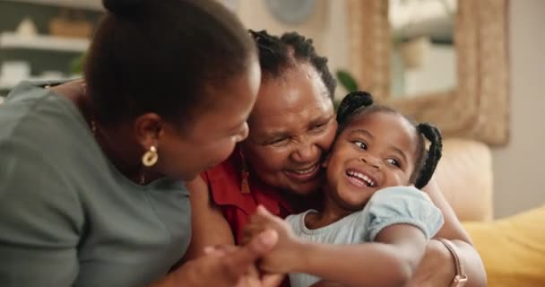 拥抱和孩子与祖母和母亲在沙发上欢笑 玩耍和结合在一起 在家里客厅里 抱着妈妈和老太太的小女孩 — 图库视频影像