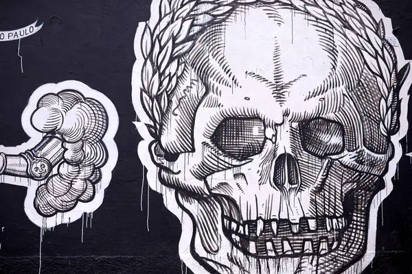 Graffiti, painting and wall mural in neighborhood with skull illustration and creativity in the city. Urban, art and black and white on a street with drawing in Sao Paulo outdoor with design tag.