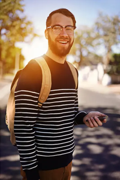 Man, smile and city with mobile phone in hand for social media or fashion for trend or browsing outdoor. Student, intern or geek and attractive person with confidence in street for hipster and style.