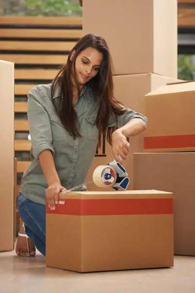 Woman, house and moving with box for packing with sealing tape in new home, ownership and property. Female person, smile and cardboard for furniture or clothes with items for apartment as investment.