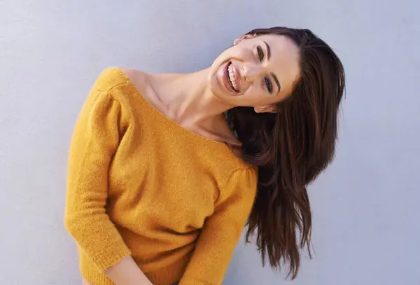 Portrait, fashion and happy woman on a wall, girl or funny model laughing isolated on purple background. Smile, face and beauty of young person in casual clothes, trendy or stylish sweater in Italy.