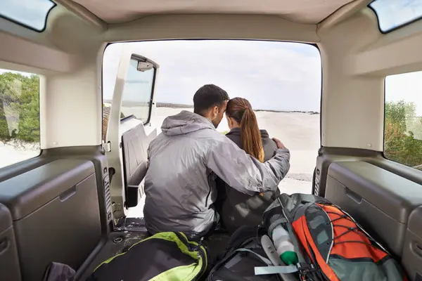 Couple, road trip and car hug for adventure, travel or transport in nature for vacation. Love, affection and motor vehicle for outdoor holiday or honeymoon or explore in dunes for rural getaway.