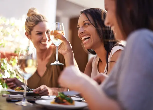 Friends, wine and women laughing at restaurant with drinking, bonding and relax outdoor in city for celebration. People, face and happy with alcohol at cafe for social gathering, funny gossip or joke.