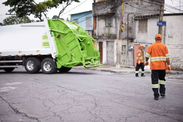Teamwork, truck and garbage collection for cleaning and disposal in waste management or trash. Dumpster refuse, cleanup by sanitation workers for rubbish removal and environmental sustainability.