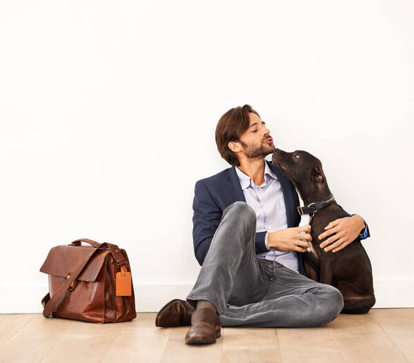 Cute, love and happy businessman with dog for bonding together with positive and good attitude. Career, briefcase and professional male person playing with pet, puppy or animal on floor at home