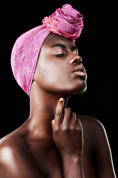 Black woman, head wrap and beauty with profile, skincare and natural cosmetics in studio. Traditional, turban and African fashion with wellness and skin glow treatment with makeup and dark background.