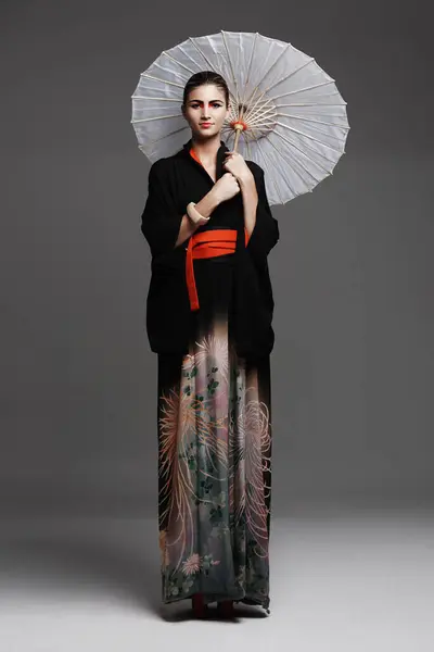 伝統的な衣装とスタジオのバックグラウンドに自信を持つ肖像画 日本の女性 スタイリッシュな服とアジアのモデルとエレガントな傘と文化や少女に誇りを持って — ストック写真