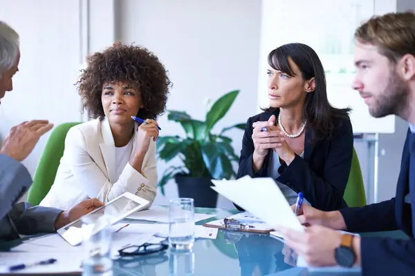Business people, teamwork or meeting with documents in conference room for financial planning, brainstorming or diversity. Professional, employees or collaboration in office for listening to strategy.