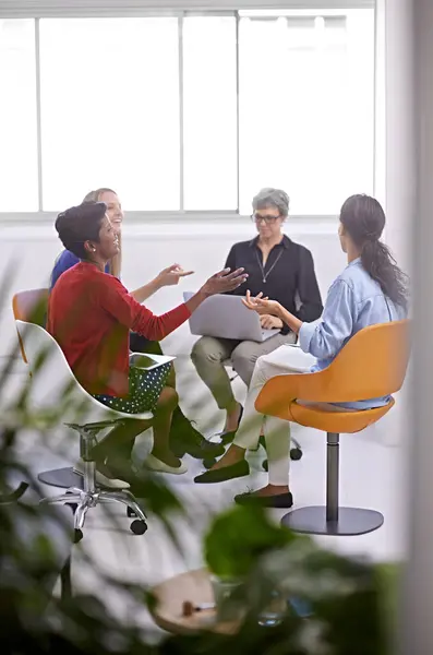 Teamwork, women or laughing with business meeting in modern office for creative planning or funny joke. Designer, employees or group with discussion with comic ideas for magazine design at workplace.