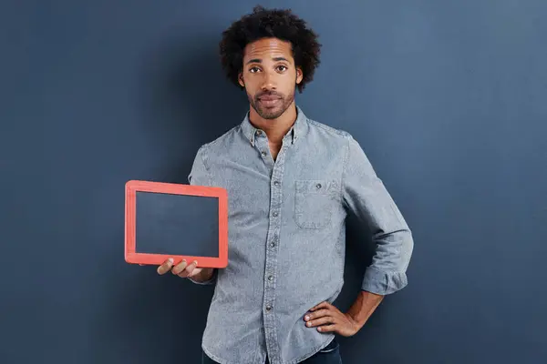 Blackboard, portrait or man with mockup in studio for news, announcement or offer on blue background. Frame, presentation or face of guy model show space for promotion, info or sign up, guide or deal.